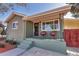 Charming front porch featuring seating and updated paint and railings at 4520 S Delaware St, Englewood, CO 80110