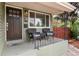 Inviting front porch with seating area, wrought iron railing, and classic door with address visible at 4520 S Delaware St, Englewood, CO 80110