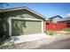 Garage with a roll up door and a well-maintained exterior and fresh green paint at 4520 S Delaware St, Englewood, CO 80110