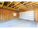 Inside of an unfinished garage with new door, high ceilings, and ample space at 4520 S Delaware St, Englewood, CO 80110