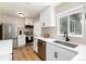 Bright, white kitchen with modern stainless steel appliances, light countertops and tile backsplash at 4520 S Delaware St, Englewood, CO 80110
