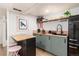 Kitchen with light wood countertops, modern appliances, and light green cabinets at 4520 S Delaware St, Englewood, CO 80110