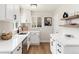 Bright kitchen featuring white cabinets, modern fixtures, stainless steel sink and light countertops at 4520 S Delaware St, Englewood, CO 80110