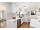 Modern kitchen featuring white cabinets, quartz countertops, stainless steel appliances, and hardwood floors at 4520 S Delaware St, Englewood, CO 80110