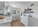 Bright kitchen with white cabinets, sleek countertops, and modern fixtures, and floating shelves at 4520 S Delaware St, Englewood, CO 80110