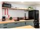 Kitchen with light wood countertops, modern appliances, and light green cabinets at 4520 S Delaware St, Englewood, CO 80110
