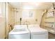 Functional laundry room with washer, dryer, storage shelves and a bright window at 4520 S Delaware St, Englewood, CO 80110