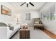 Bright living room featuring hardwood floors, a ceiling fan, natural light, and a modern chaise lounge at 4520 S Delaware St, Englewood, CO 80110