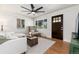 Comfortable living room with hardwood floors, a ceiling fan, natural light, and modern furniture at 4520 S Delaware St, Englewood, CO 80110