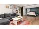 Finished basement living room area with bedroom in the background at 4520 S Delaware St, Englewood, CO 80110