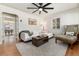 Cozy living room featuring hardwood floors, white sectional, and a view into the dining area at 4520 S Delaware St, Englewood, CO 80110