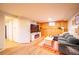 Inviting living room with a large TV, comfortable gray couch, and a cozy fireplace at 4520 S Delaware St, Englewood, CO 80110