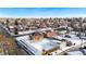 Aerial view of neighborhood, showcasing a brick home and snowy landscape at 501 S Dale Ct, Denver, CO 80219