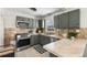 L-shaped kitchen with sage green cabinets and tile countertops at 501 S Dale Ct, Denver, CO 80219