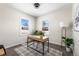 Bright home office with a wooden desk, two windows, and a neutral color scheme at 501 S Dale Ct, Denver, CO 80219