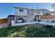 Backyard featuring a deck with stairs and grassy yard at 4036 S Himalaya Cir, Aurora, CO 80013