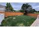Large backyard featuring a wooden fence and well-maintained grass at 4036 S Himalaya Cir, Aurora, CO 80013