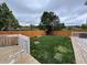 Large backyard with wood fence and grass at 4036 S Himalaya Cir, Aurora, CO 80013