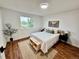 Bright bedroom with hardwood floors, large window, and stylish decor at 4036 S Himalaya Cir, Aurora, CO 80013