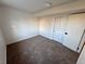 Clean bedroom featuring carpet, a sliding closet door, and minimalist design for a cozy feel at 4036 S Himalaya Cir, Aurora, CO 80013
