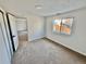 Bright bedroom featuring neutral carpeting, natural light, and closet space at 4036 S Himalaya Cir, Aurora, CO 80013