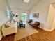 Cozy living room with neutral decor, a sliding glass door, and wood-look flooring at 4036 S Himalaya Cir, Aurora, CO 80013