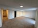 Carpeted living room with connecting rooms and neutral paint, ready for personalization at 4036 S Himalaya Cir, Aurora, CO 80013