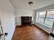 Bright room featuring wood flooring, a piano, and a large window, providing a comfortable space at 4036 S Himalaya Cir, Aurora, CO 80013