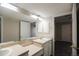 Bathroom with built-in shelving and double sinks is conveniently connected to bedroom at 2162 Concord Ln, Superior, CO 80027