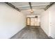 A clean garage featuring a storage shelf and a white door with a brass handle at 2162 Concord Ln, Superior, CO 80027