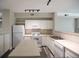 Bright kitchen includes modern appliances, light countertops, island, and open floor plan at 2162 Concord Ln, Superior, CO 80027