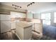 Well-lit kitchen boasts essential appliances, light countertops, island, and an open design at 2162 Concord Ln, Superior, CO 80027