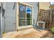 Backyard features sliding glass doors and an air conditioning unit on the patio at 14242 E Hawaii Cir # C, Aurora, CO 80012