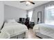 Bright bedroom featuring two beds, desk, and ceiling fan, perfect for a shared space at 14242 E Hawaii Cir # C, Aurora, CO 80012