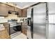 Modern kitchen featuring stainless steel appliances and dark cabinetry at 14242 E Hawaii Cir # C, Aurora, CO 80012