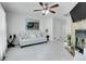 Bright living room with a stylish mirror, ceiling fan, neutral color palette, and a cozy stone fireplace at 14242 E Hawaii Cir # C, Aurora, CO 80012