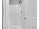 Clean, white tiled shower with a shower curtain for a minimalist and modern look at 14242 E Hawaii Cir # C, Aurora, CO 80012