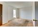 Neutral bedroom featuring a window and wood door at 6650 E Arizona Ave # 138, Denver, CO 80224