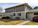 View of a two-story townhome featuring a well-manicured lawn and sidewalk at 6650 E Arizona Ave # 138, Denver, CO 80224