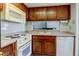 Functional kitchen featuring appliances, cabinetry, and tile backsplash at 6650 E Arizona Ave # 138, Denver, CO 80224