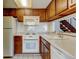 Functional kitchen featuring appliances, cabinetry, and tile backsplash at 6650 E Arizona Ave # 138, Denver, CO 80224