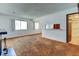 Open living room area with a fireplace and view to an adjoining room and a bathroom at 6650 E Arizona Ave # 138, Denver, CO 80224