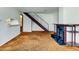 Cozy living room with fireplace and staircase, offering a blend of comfort and functionality at 6650 E Arizona Ave # 138, Denver, CO 80224
