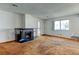 Bright living room featuring a decorative fireplace and a large window with natural light at 6650 E Arizona Ave # 138, Denver, CO 80224