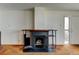 Living room featuring a fireplace, carpet, and door at 6650 E Arizona Ave # 138, Denver, CO 80224