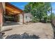 Large backyard with a covered patio area, mature trees, and ample space at 920 Emerson Cir, Northglenn, CO 80233