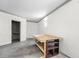 Partially finished basement with workbench, storage shelves, and bright light at 920 Emerson Cir, Northglenn, CO 80233