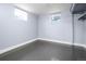 Finished basement area with windows, gray flooring, and neutral-colored walls at 920 Emerson Cir, Northglenn, CO 80233