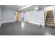 Spacious basement area with light blue walls and multiple access doors at 920 Emerson Cir, Northglenn, CO 80233
