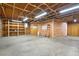 Unfinished basement with open wood beams, shelving, and concrete floor at 920 Emerson Cir, Northglenn, CO 80233